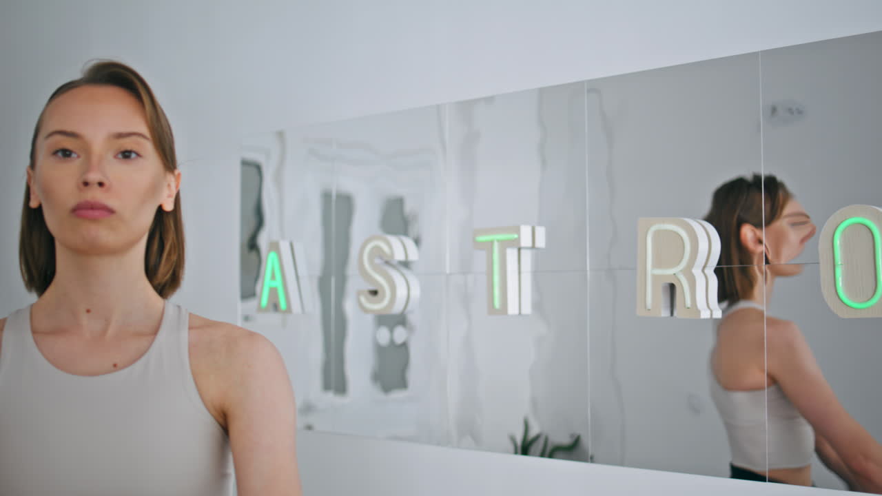 Athlete lady lifting dumbbells indoors close up. Motivated woman weight training