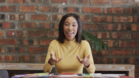 happy african american casual businesswoman having video call, talking and gesturing, slow motion