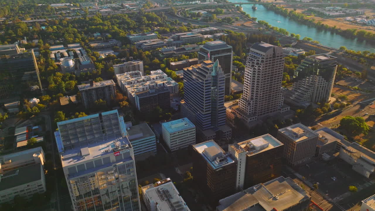 Modern scenery of Sacramento, California, USA. Lovely green city panorama on sunny daytime. River at backdrop.
