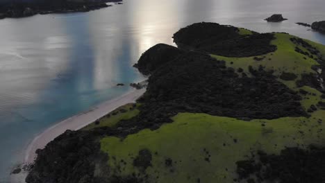 drone tilting up from the mountain top of urupukapuka island to the whole seascape