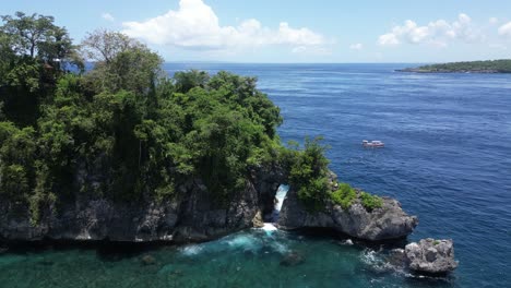 small isolated island off the coast of nusa penida on a hot summers day, aerial