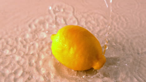 Lemon-spinning-on-wet-white-surface