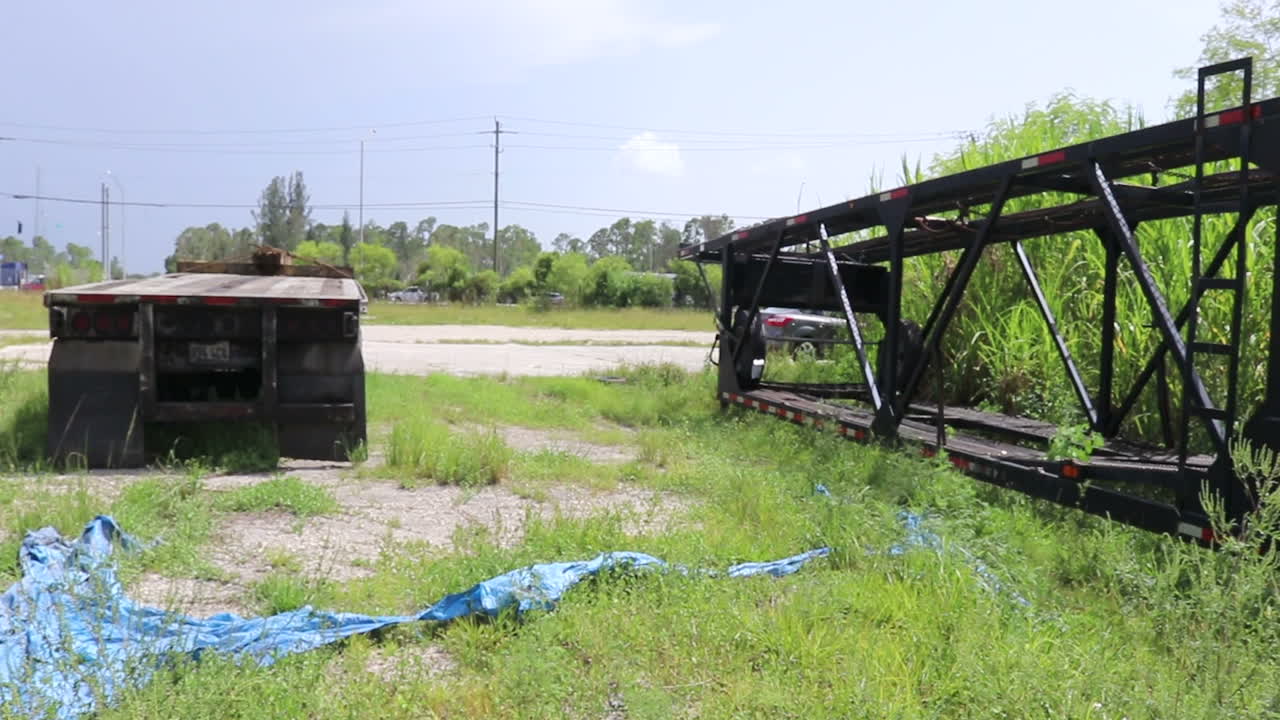 Lonely trailer and flat bed on the edge of the town