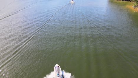 chasing a v-hull boat across lake channel with several other boats