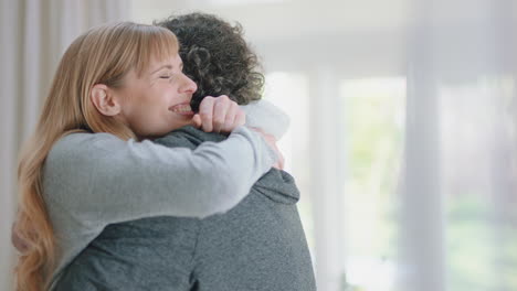 happy couple hugging excited woman embracing boyfriend sharing good news enjoying romantic relationship at home 4k footage