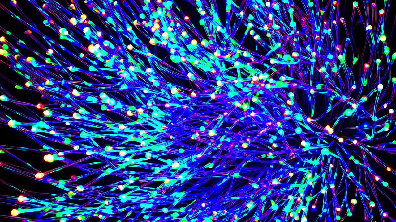 Vibrant motion sequence of colorful lights swirling dynamically, creating a mesmerizing visual flow with a captivating energy and rhythm