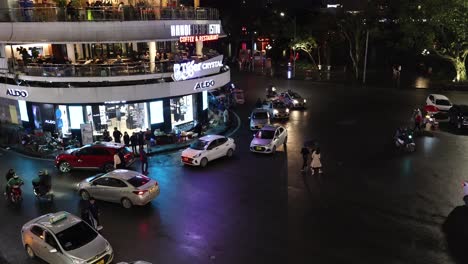 vehicles and pedestrians navigating busy intersection