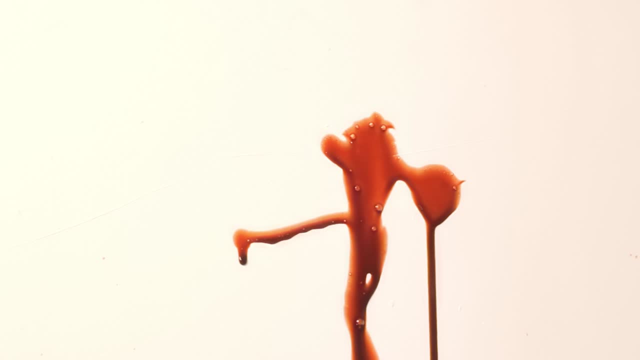 Small Amount of Red Fake Blood Splattered on White Wall. Shiny Thick Liquid Spatter Dripping. Realistic Slime Texture for Horror. Violent Crime Scene Halloween Spooky Background