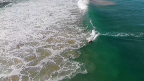 bodyboarder rides perfect wave, 360 spin, sintra