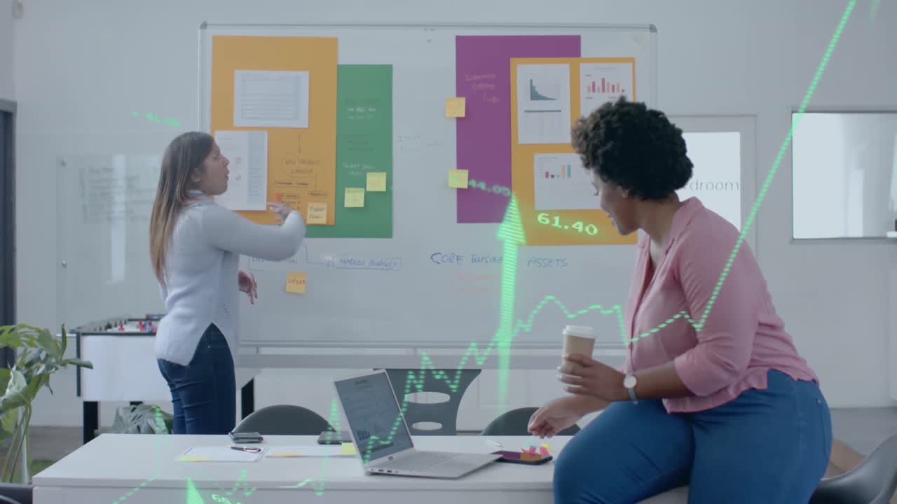 Green graph and up arrows over diverse female colleagues brainstorming at casual office meeting