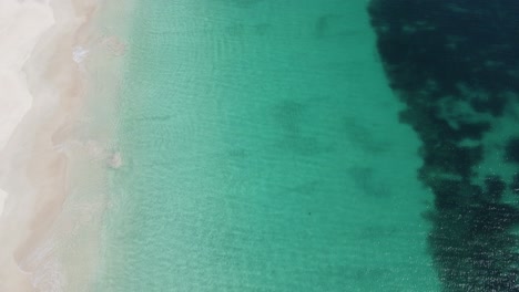 Aerial-view-of-clear-ocean-and-white-sand-on-a-summers-days-in-Mindarie-Perth-Western-Australia