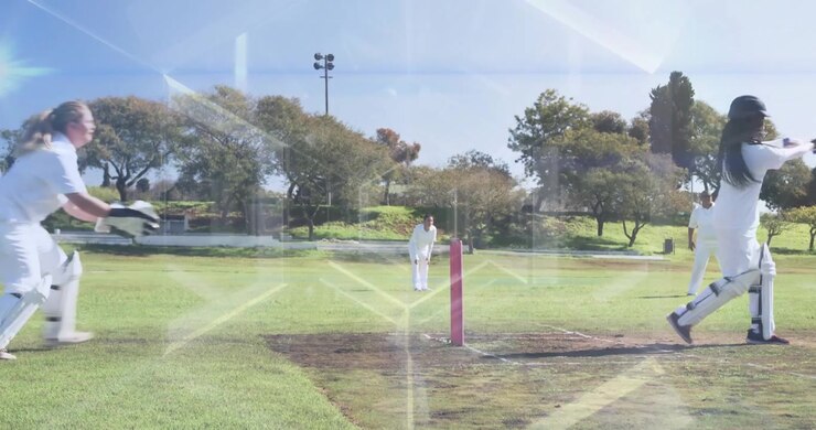Lanciatore di cricket che corre, il wicket-keeper che rompe i bails mentre il battitore si lancia sulla linea di battuta evitando lo stumping.