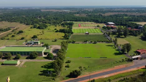 aerial view of high performance soccer athletes, green grass field, on a sunny day, paraguay