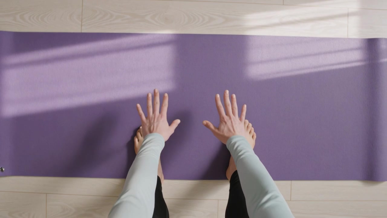 Toes appearing woman in black leggings preparing stretch planting palms leaning on purple mat home