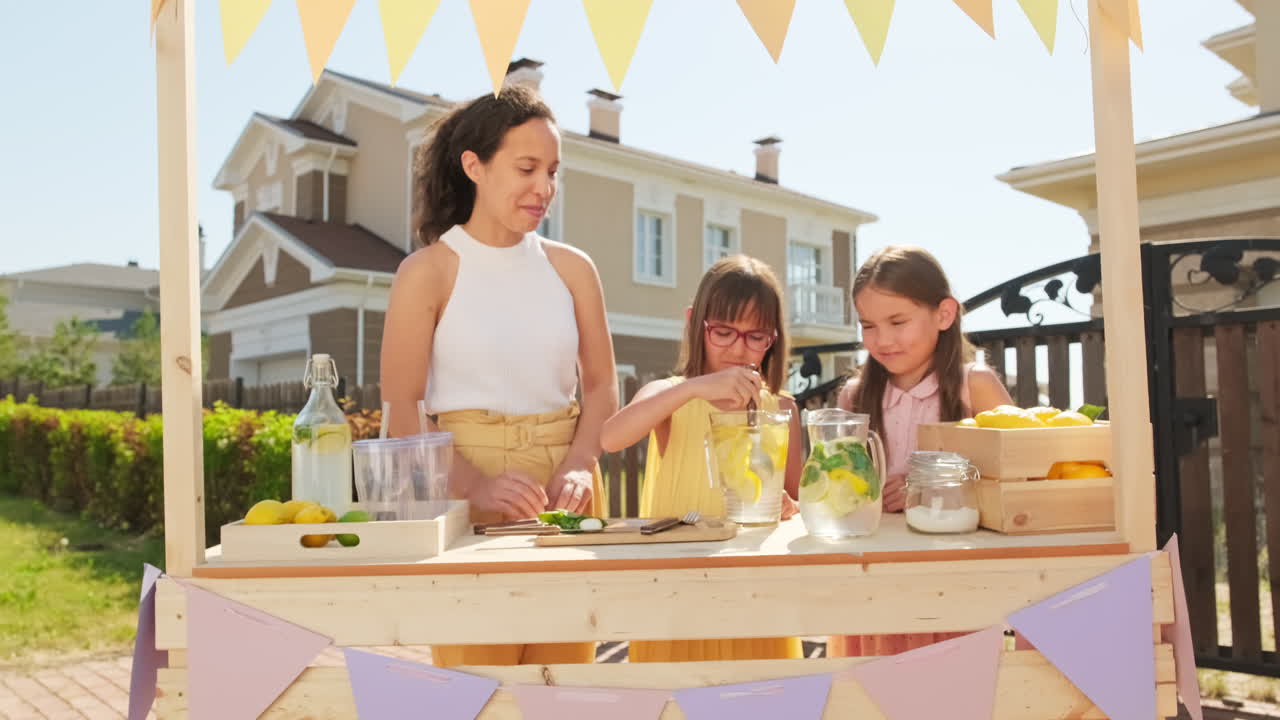 Mom With Daughters Making Lemonade For Market