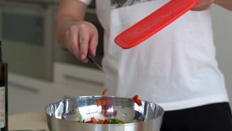 man chopping vegetables for salad