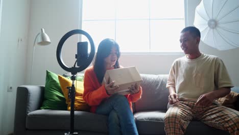 couple unboxing and reviewing a product for their youtube channel
