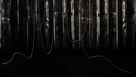 animation of hanging cables and wooden boards on dark background