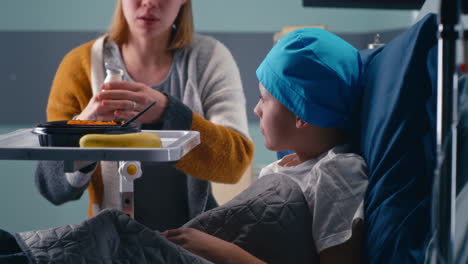 mother feeding child in hospital