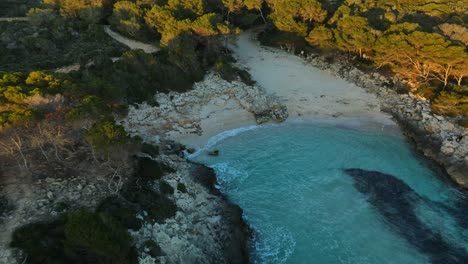 Waves-calmly-washing-ashore-on-Es-talaier-beach-in-Menorca-with-soft-lighting