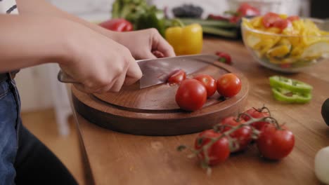 handheld view of wooden board and freshness tomatoes slices/rzeszow/poland