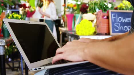 close-up of florist using laptop