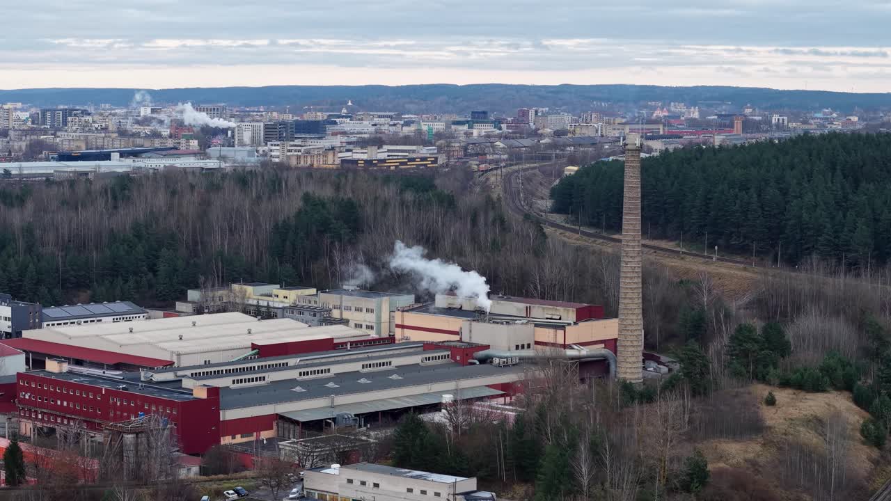Industrial zone with smoking chimney in Vilnius, aerial view