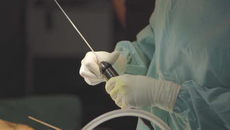 plastic surgeon manipulating a suction catheter for fat removal on argentina