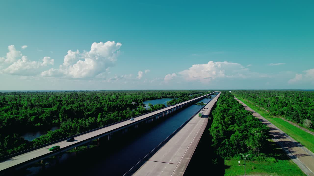Smooth drone flyover following a dry van semi truck on I-55 through Laplace, Louisiana—ideal for transportation, logistics, and commercial highways.