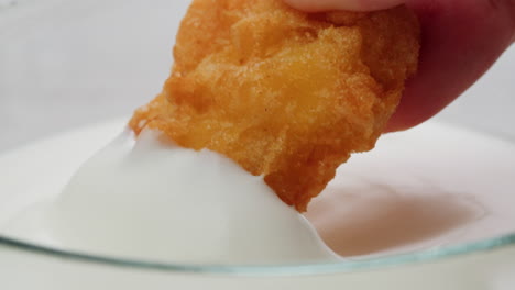 chicken nuggets dipping in sauce