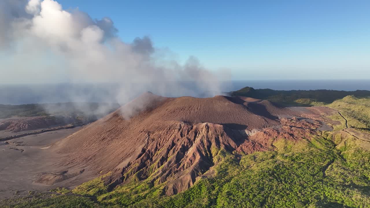 Steaming volcano and volcanic coastal landscape of Tanna Island, Vanuatu. Drone pull back
