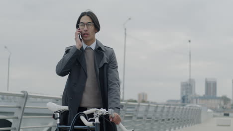 man on a bicycle talking on a phone