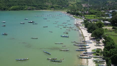 clear water and multiple boats on the coast of lombok, indonesia on a hot summers afternoon