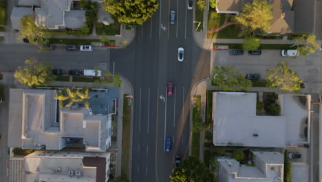 Aerial-view-above-traffic-the-streets-of-Beverly-Hills,-sunny-evening-in-LA---top-down,-drone-shot