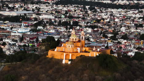 telezoom drone shot circling the church on the cholula pyramid, sunset in mexico