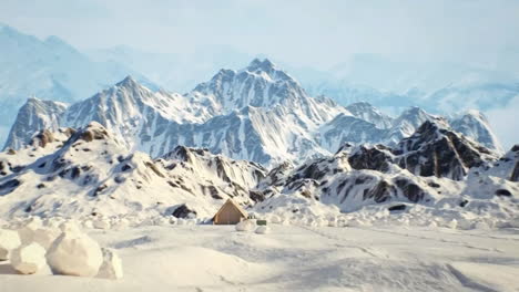 snowy mountain scenery with tent