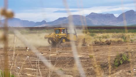 yellow tracked bulldozer machine on a deserted dirty landscape