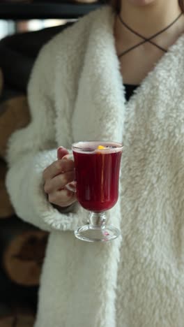 woman holding a cup of mulled wine