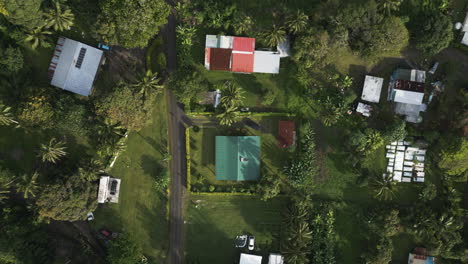 drone top down descend on rural home in cook islands rarotonga