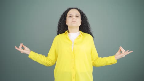 young woman meditating looking at camera.