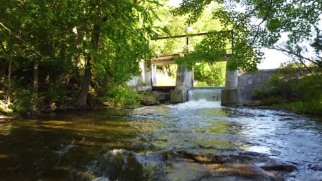 Drone-forward-shot-traces-the-flow-of-an-irrigated-river-at-the-mouth-of-a-river-near-Georgian-Bay,-Ontario,-Canada