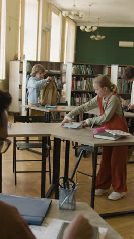 children and students preparing in a classroom or library