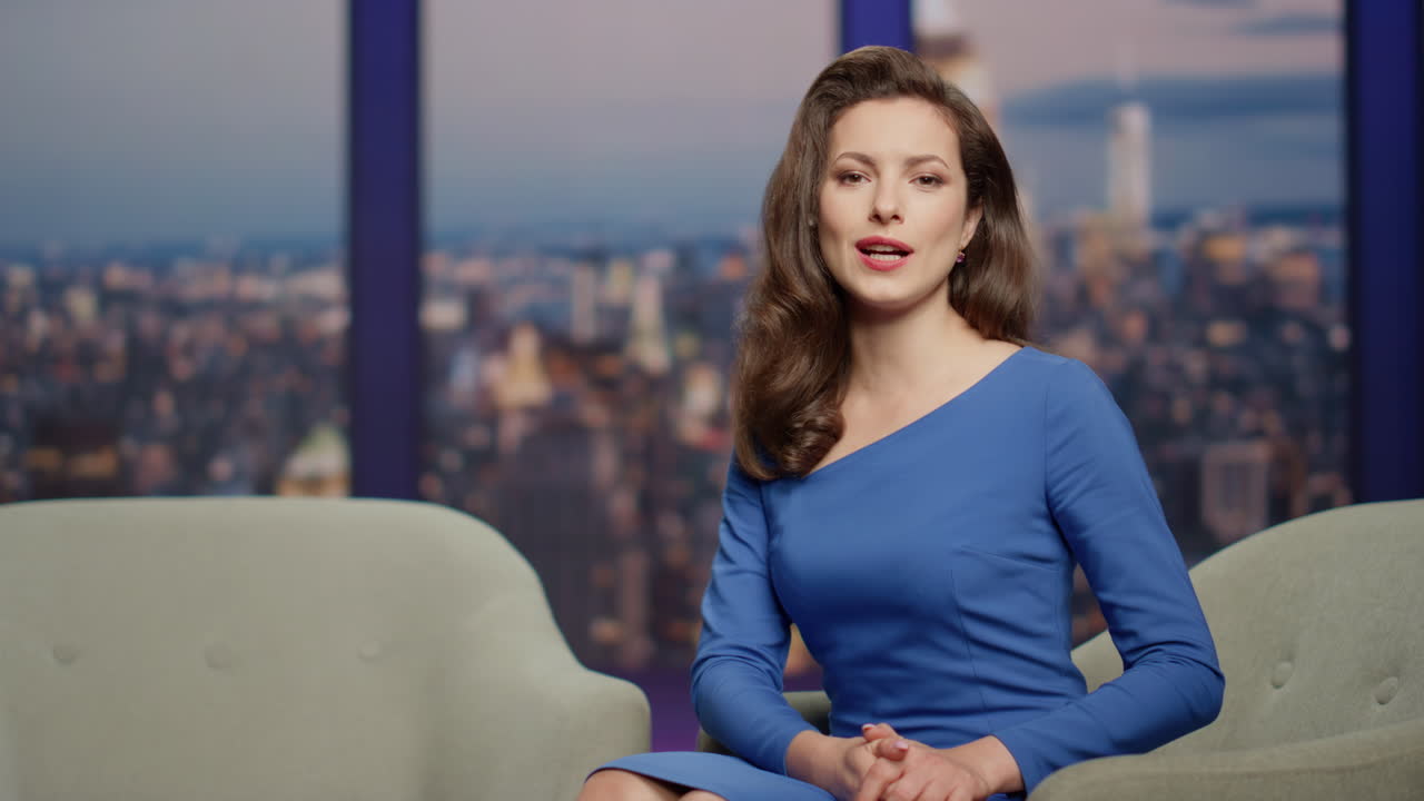 tv 프로그램 스튜디오 클로즈업에서 남성 유명인을 소개하는 우아한 커 여성.