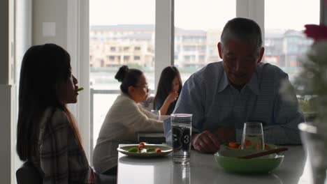 Cute-asian-granddaughter-and-old-senior-grandfather-eating-food-in-a-comfortable-home-4k