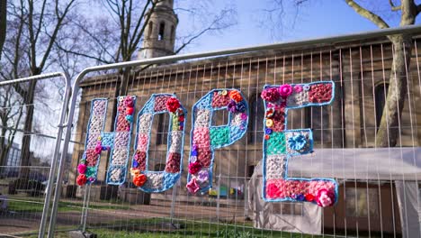 yarn-bombed 'hope' sign in front of a church