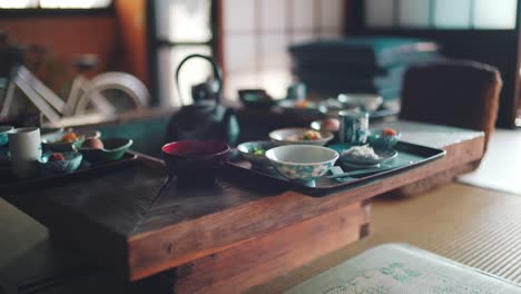 trays of japanese breakfast served on a traditional irori table in wakayama, japan - selective focus, static shot