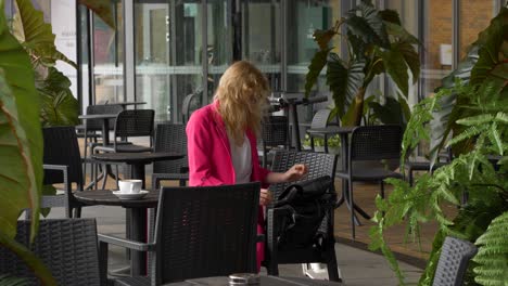 business woman packs her laptop to backpack and goes to work with electric scooter