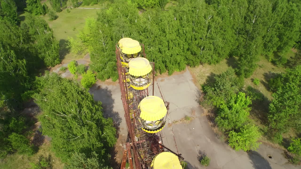 Aerial view of the abandoned Ferris wheel in Pripyat, Ukraine. Overgrown with vegetation, a haunting, desolate scene