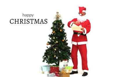 Fröhlicher-Weihnachtstext-Und-Weihnachtsmann-Neben-Dem-Weihnachtsbaum