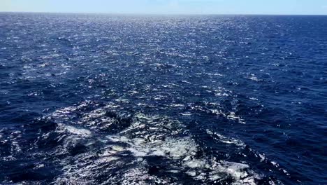 caribbean waters roll past, with its deep blue color